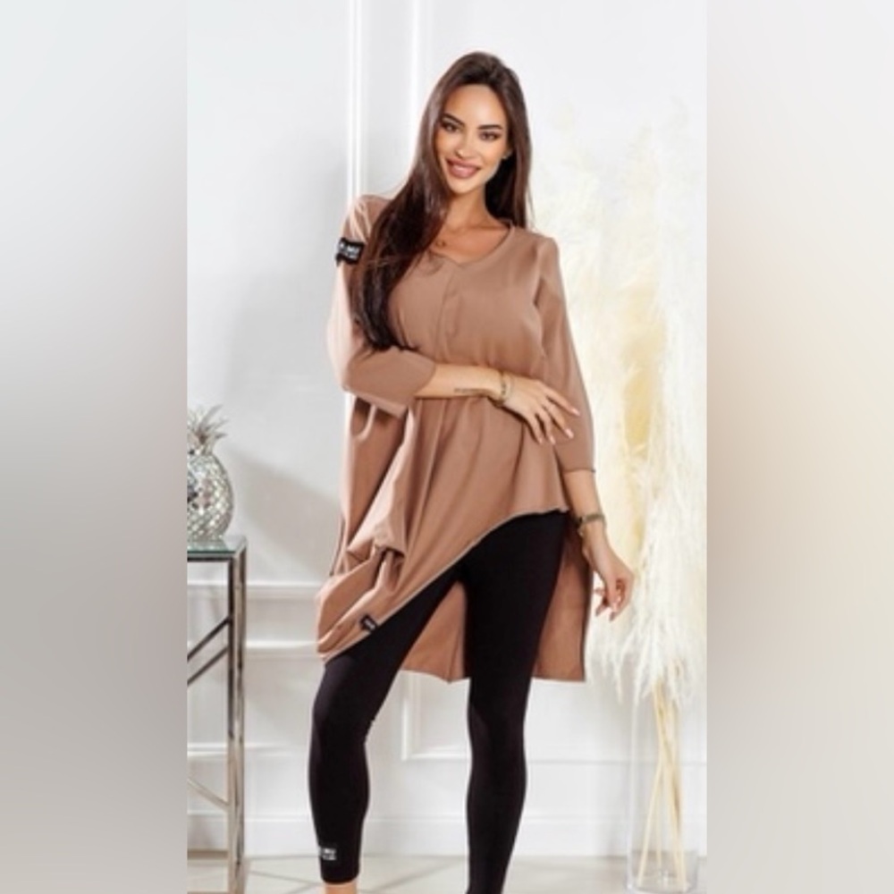 MAKE AN OFFER!
Tan non symetrical Tunic with Black Accents
Stylish, unique look
